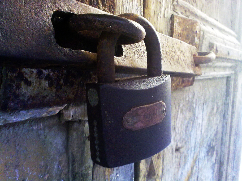 Old padlock on a door latch